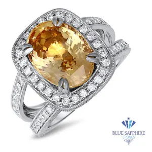 6.58ct Oval Orangey Peach Sapphire with diamond halo in 18K White Gold